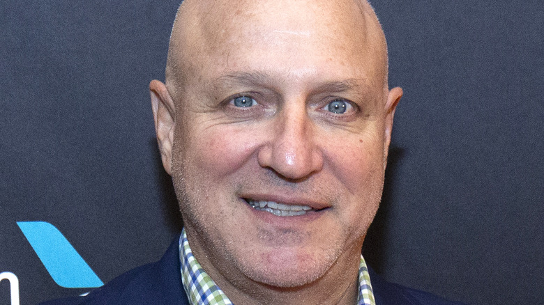 Tom Colicchio smiling unevenly