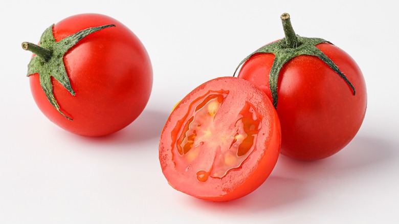 Three tomatoes on white background