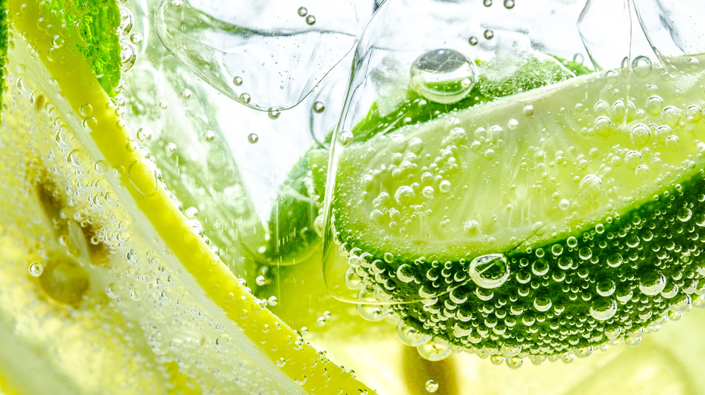 Sparkling water with lime slices close up