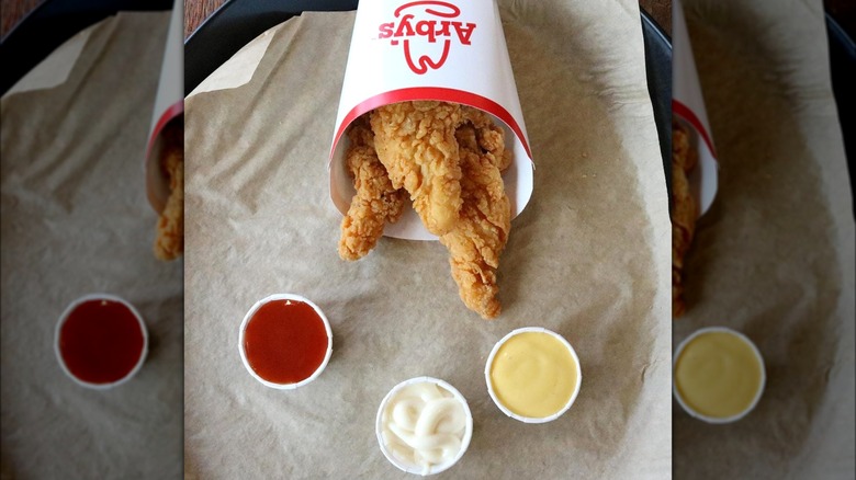 Arby's chicken tenders with several dipping sauces.