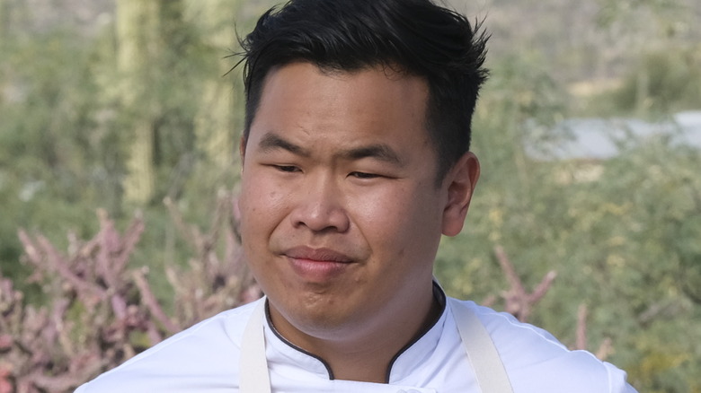 Buddha Lo in chef's jacket and apron