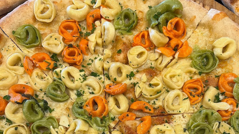 multicolored tortellini on a pizza