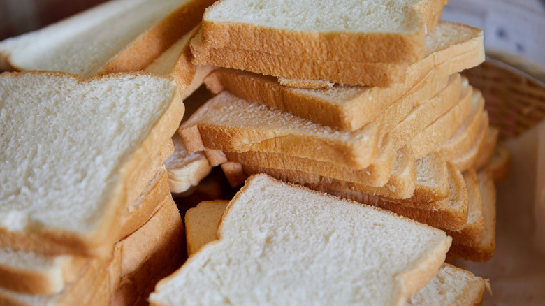 Slices of white bread in a stacked pile