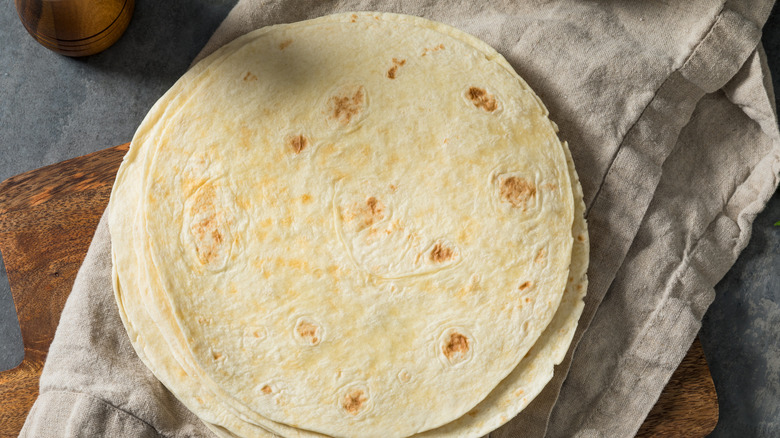 Pile of flour tortillas on a grey cloth