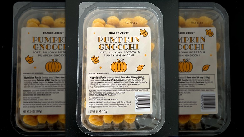 A sealed package of Trader Joe's pumpkin gnocchi against a black background.