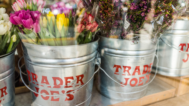 Metal flower buckets with Trader Joe's logo in store window