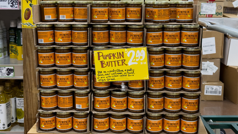 Trader Joe's pumpkin butter jars with a sign labeled "Pumpkin Butter $2.99" sitting in front of them.