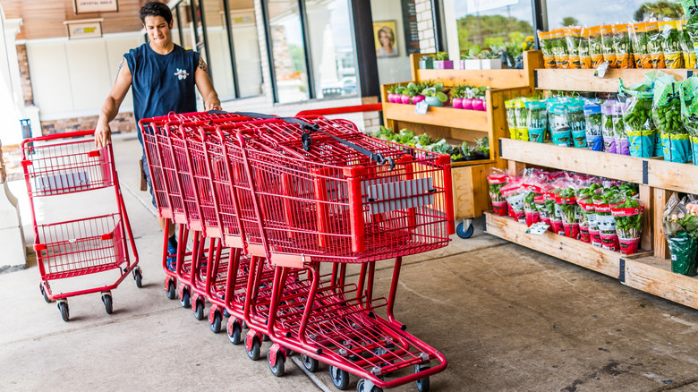 Trader Joe's employee collecting carts in front of the store