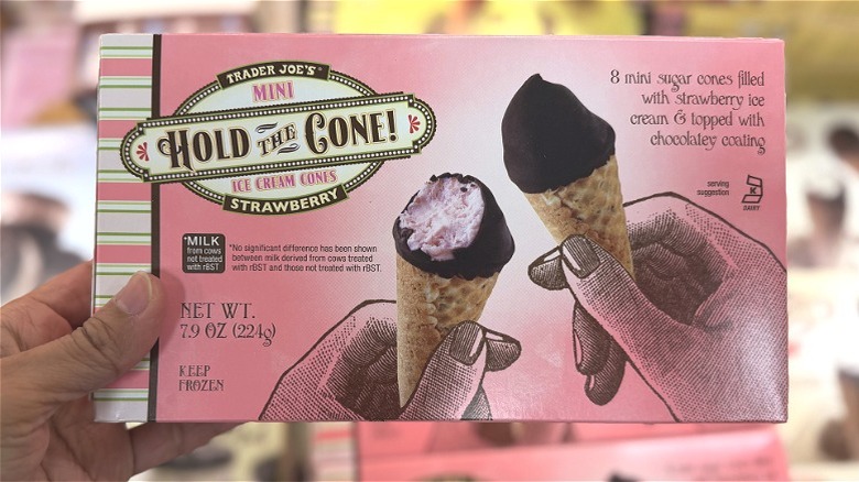 Hand holding a box of Trader Joe's mini Hold the Cone strawberry ice cream cones