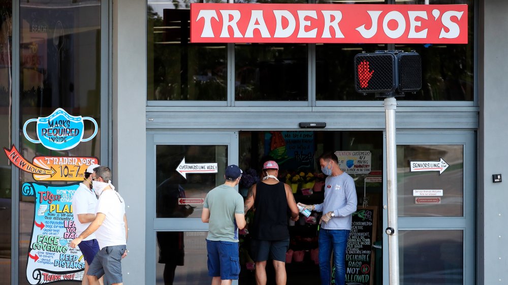 Trader Joes employee distributes hand sanitizer