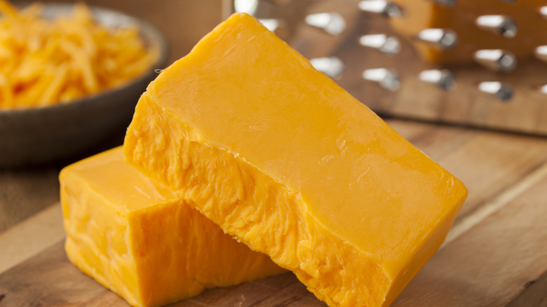 Cheddar cheese on brown wood