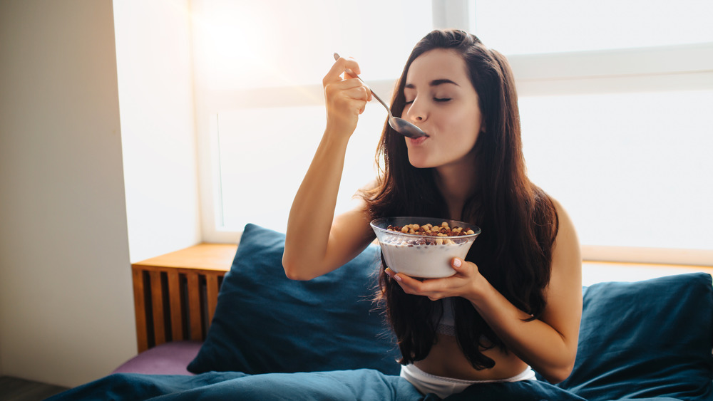 Woman eating bowl of cereal