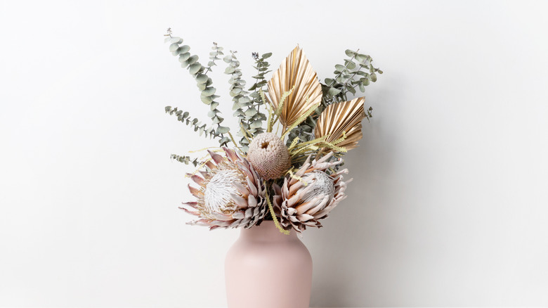 dried flowers in a pink vase