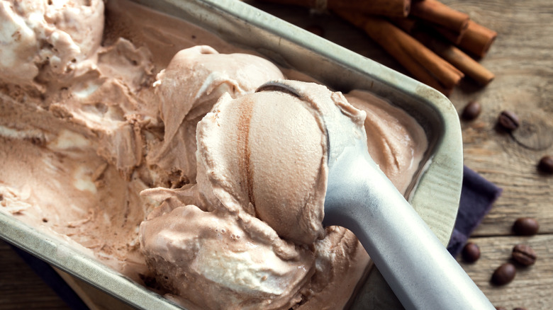 A container of ice cream with an ice cream scoop