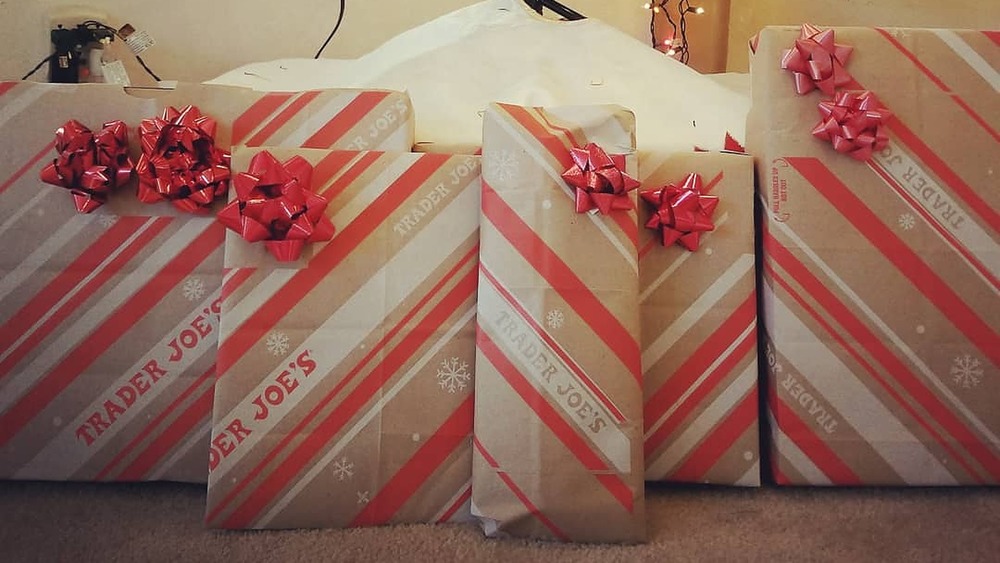 presents under tree wrapped with Trader Joe's paper bags