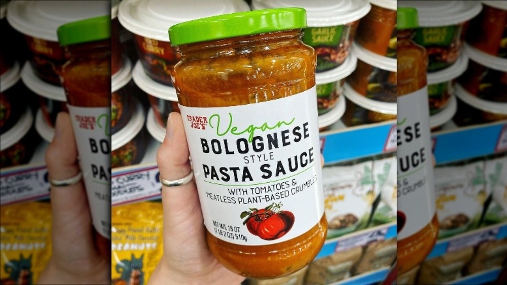 Hand holding a jar of the new pasta sauce