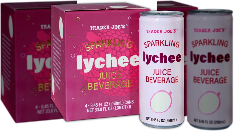 Box of lychee flavored beverage next to two cans of the same juice.