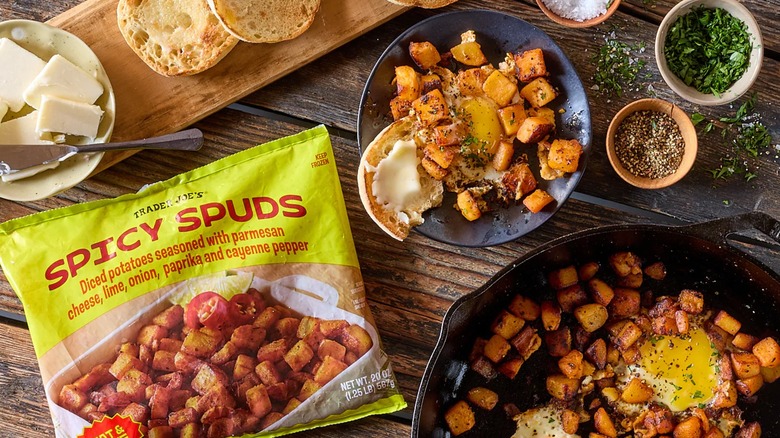 Bag of spicy seasoned diced potatoes next to others foods.