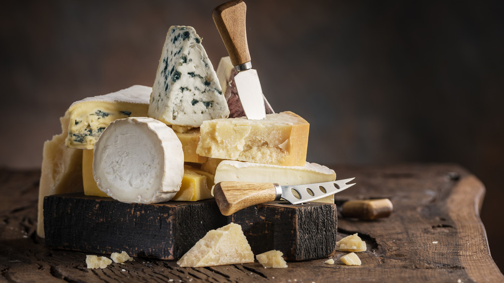 Variety of cheeses on cutting board