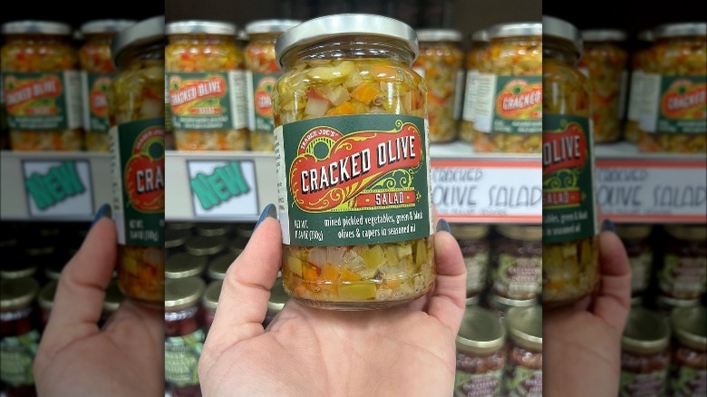 hand holding olive salad jar