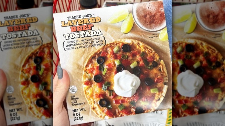 Person holding a Layered Beef tostada from Trader Joe's