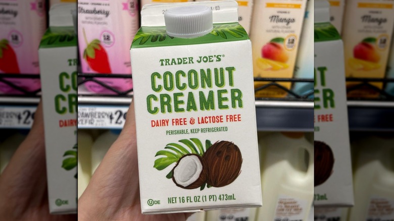 Hand holding Trader Joe's Coconut Creamer