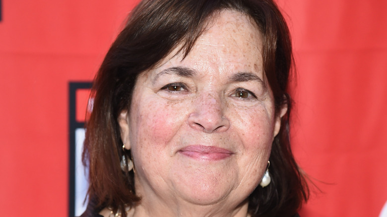 Ina Garten against a red backdrop
