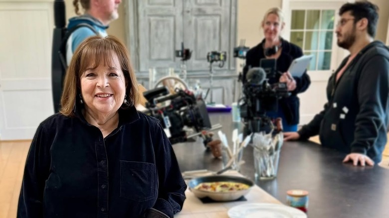 Ina Garten in the kitchen with a film crew