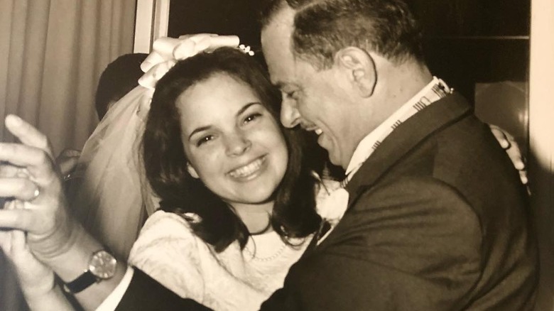 black and white photo of a young ina garten as a bride dancing with her father