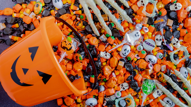 Pumpkin pail spilling Halloween candy