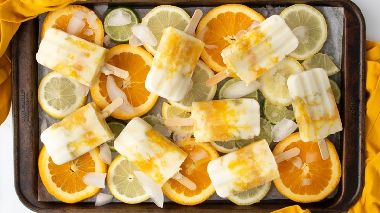 popsicles and citrus on sheet pan