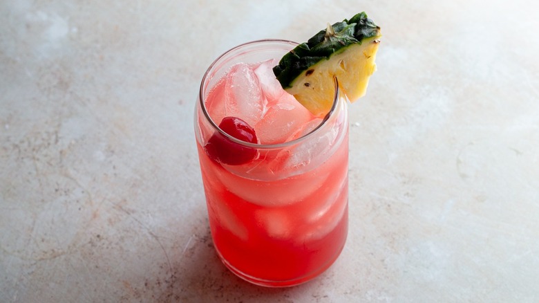 rum runner with pineapple and cherry garnish