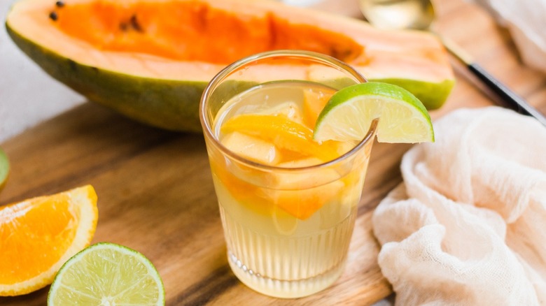 Glass of tropical sangria with papaya and lime