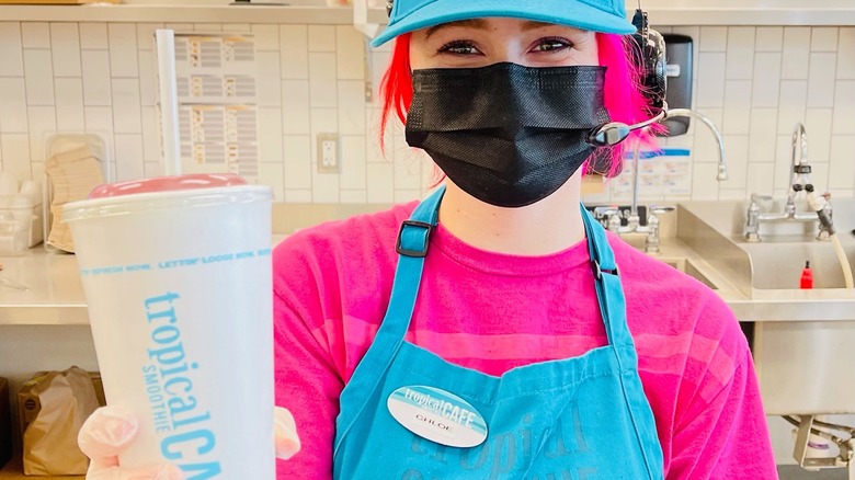 Tropical Smoothie Cafe worker serving smoothie 