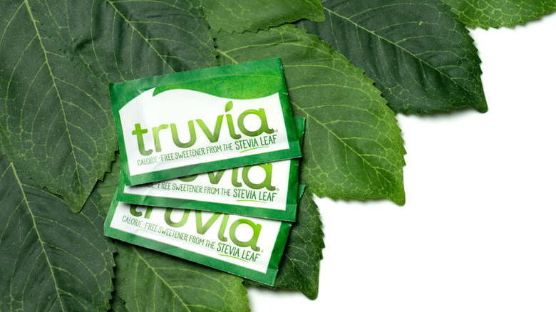 Truvia packets on top of green leaves