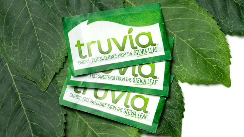 Truvia packets on top of green leaves