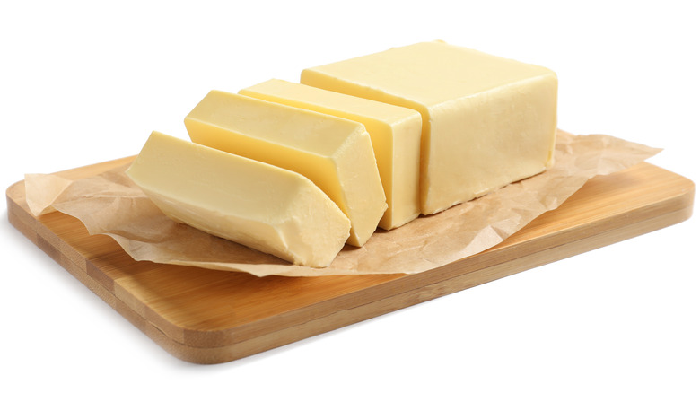 Chopped blocks of butter on wooden board