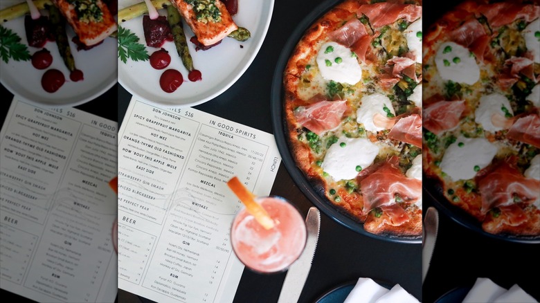 Pizza, appetizers, drink, and menu on table at Mediterraneo restaurant in Greenwich, Connecticut
