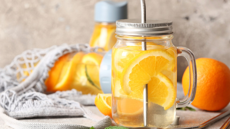 Mason jar with a metal straw and infused water