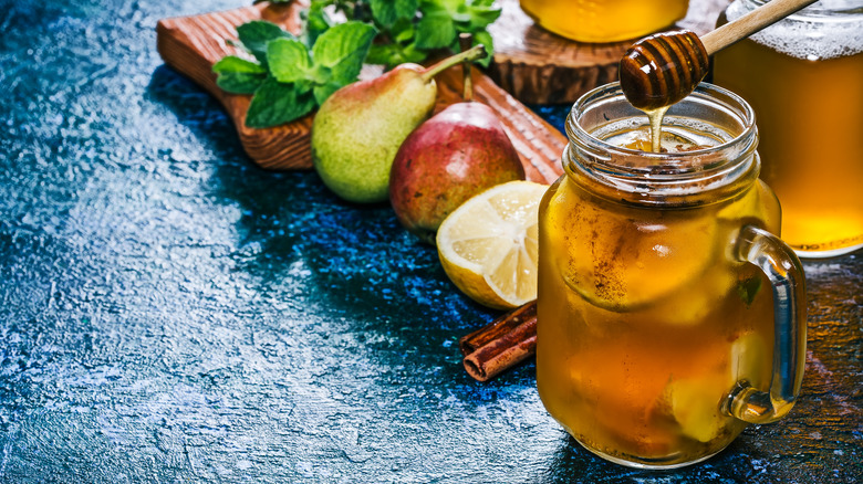 Glass of sangria with fruit and honey