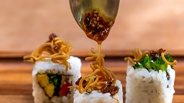 pouring eel sauce over sushi