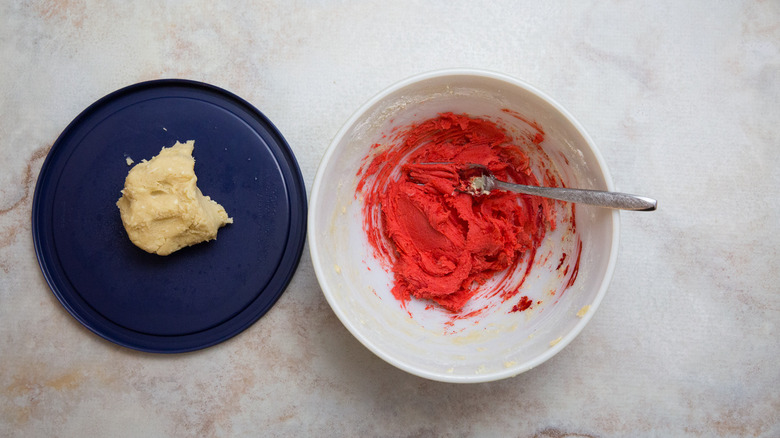Plain sugar cookie dough next to red cookie dough