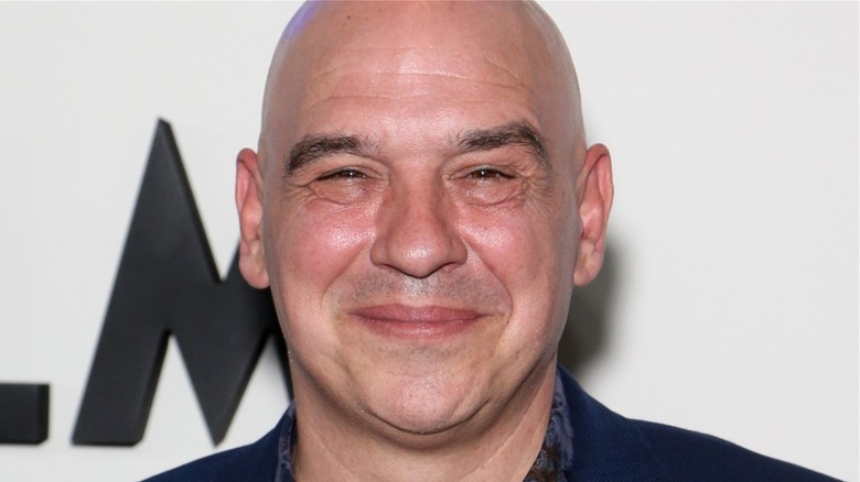 beardless Michael Symon smiling