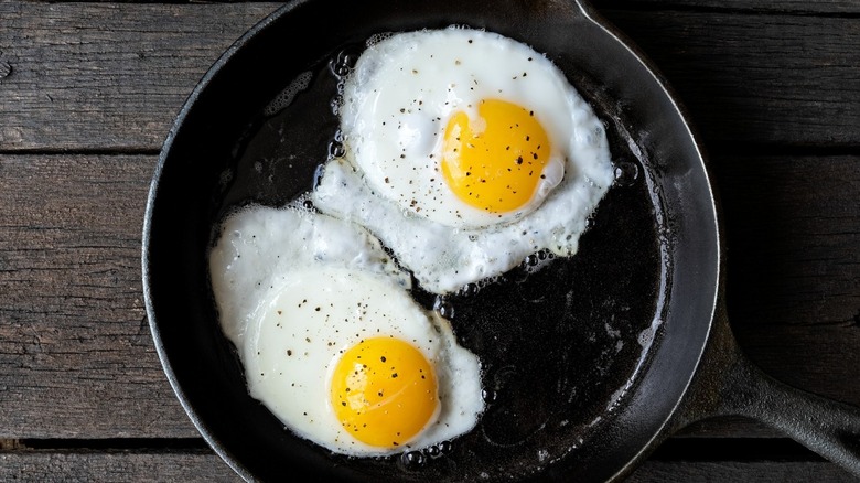 two fried eggs in frying pan