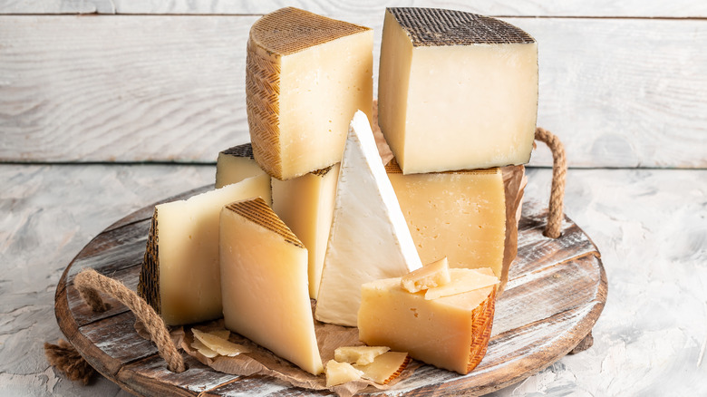 Cheese wedges on wooden board