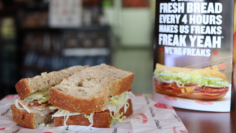 Jimmy John sandwich with a sign setting on a table