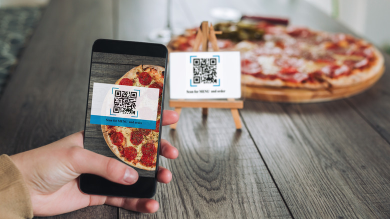 A person scanning a QR code for a menu