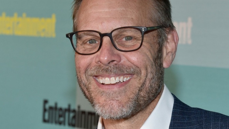 Alton Brown grinning in glasses