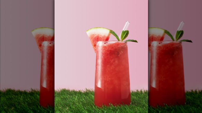 Watermelon drink with a melon slice and mint garnish