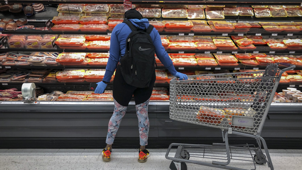 Woman looking at Tyson food in meat section